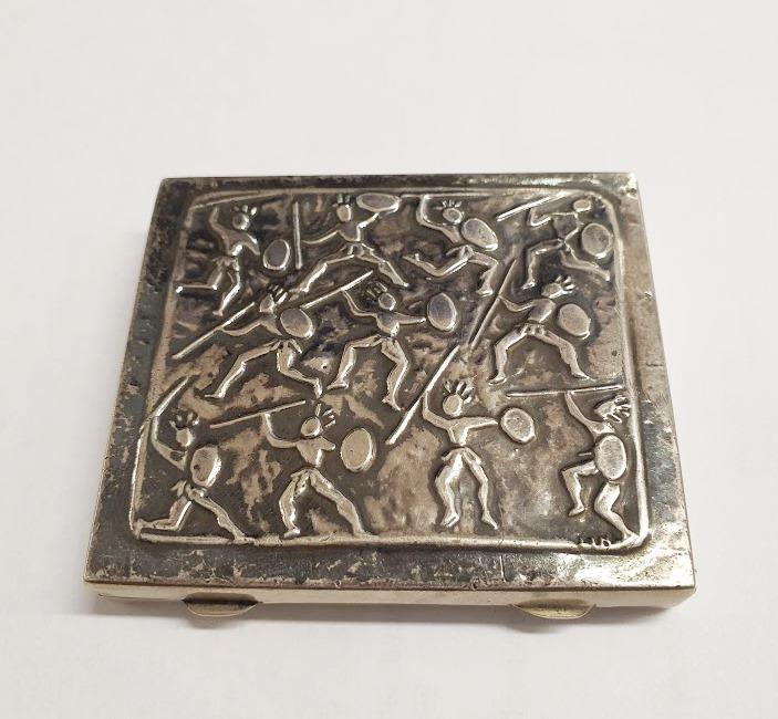 Kovové pouzdro s motivy bojovníků