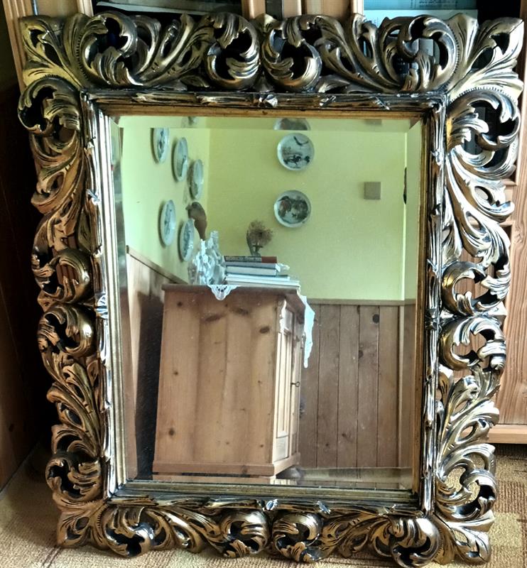 Fasetové zrcadlo v akantovaném řezaném rámu.