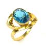 Zlacený stříbrný prsten s modrým kamenem